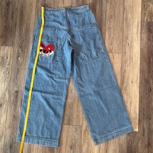 Relaxed Fit Blue Men’s Jeans with Red Graphic Pocket. 13 inch wide leg